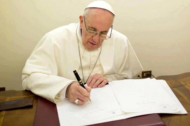Pope Francis writing 740x493